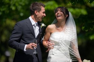 Bride and Groom laughing at their wedding
