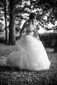Bride checking her dress in the woods