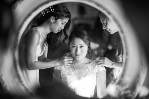 bride getting ready in front of the mirror