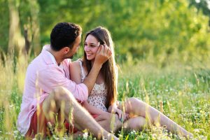 Engagement couple he is touching her hair she is smiling