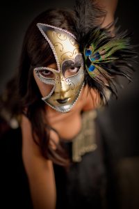 masked girl dancing with feathers